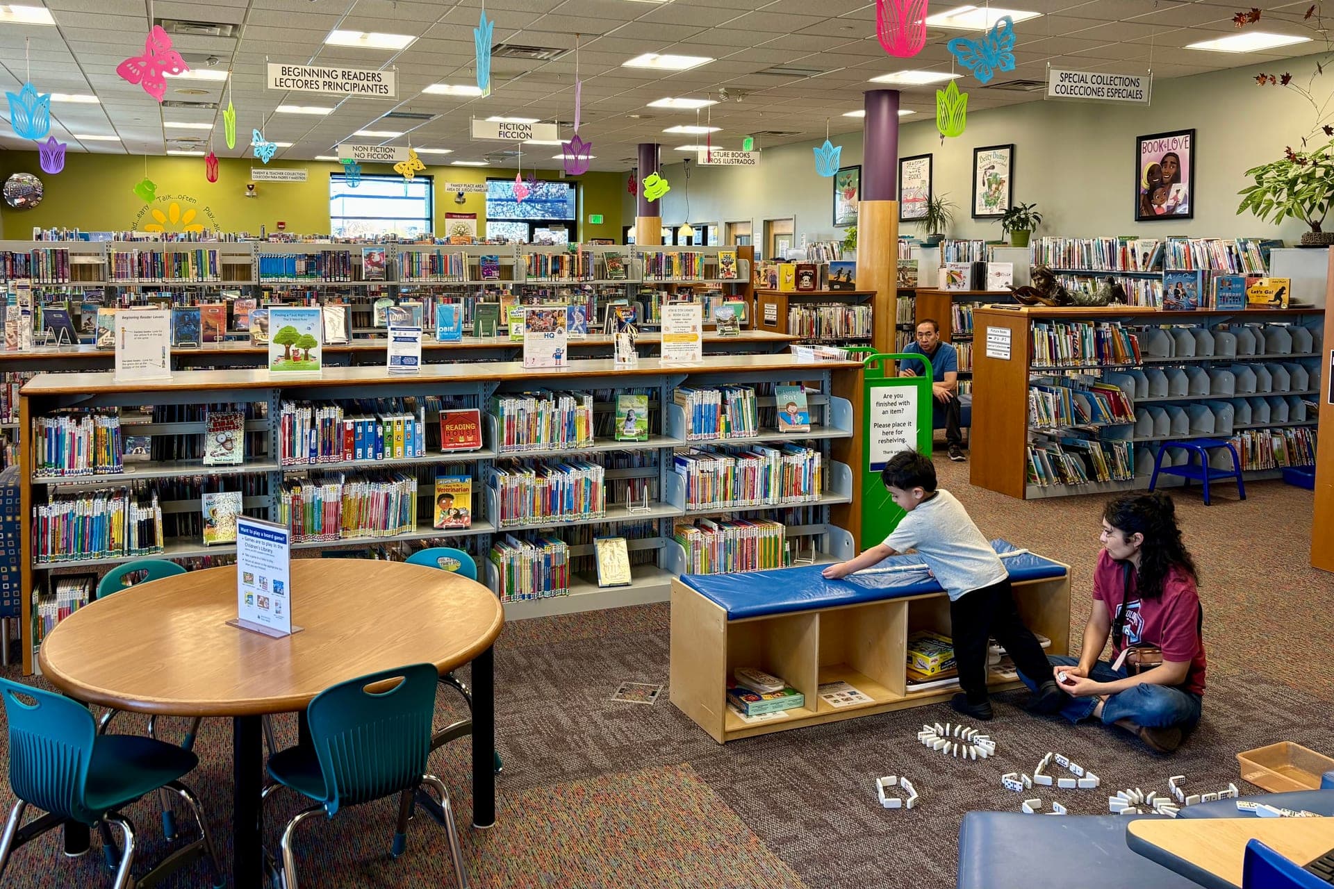 Colourful children's library with picture-book shelves and a reading nook
